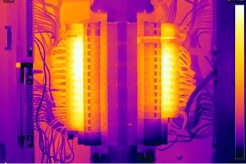 Thermal imaging of twin electrical distribution panels showing uniform heat distribution and hotspot analysis as part of professional thermography services.